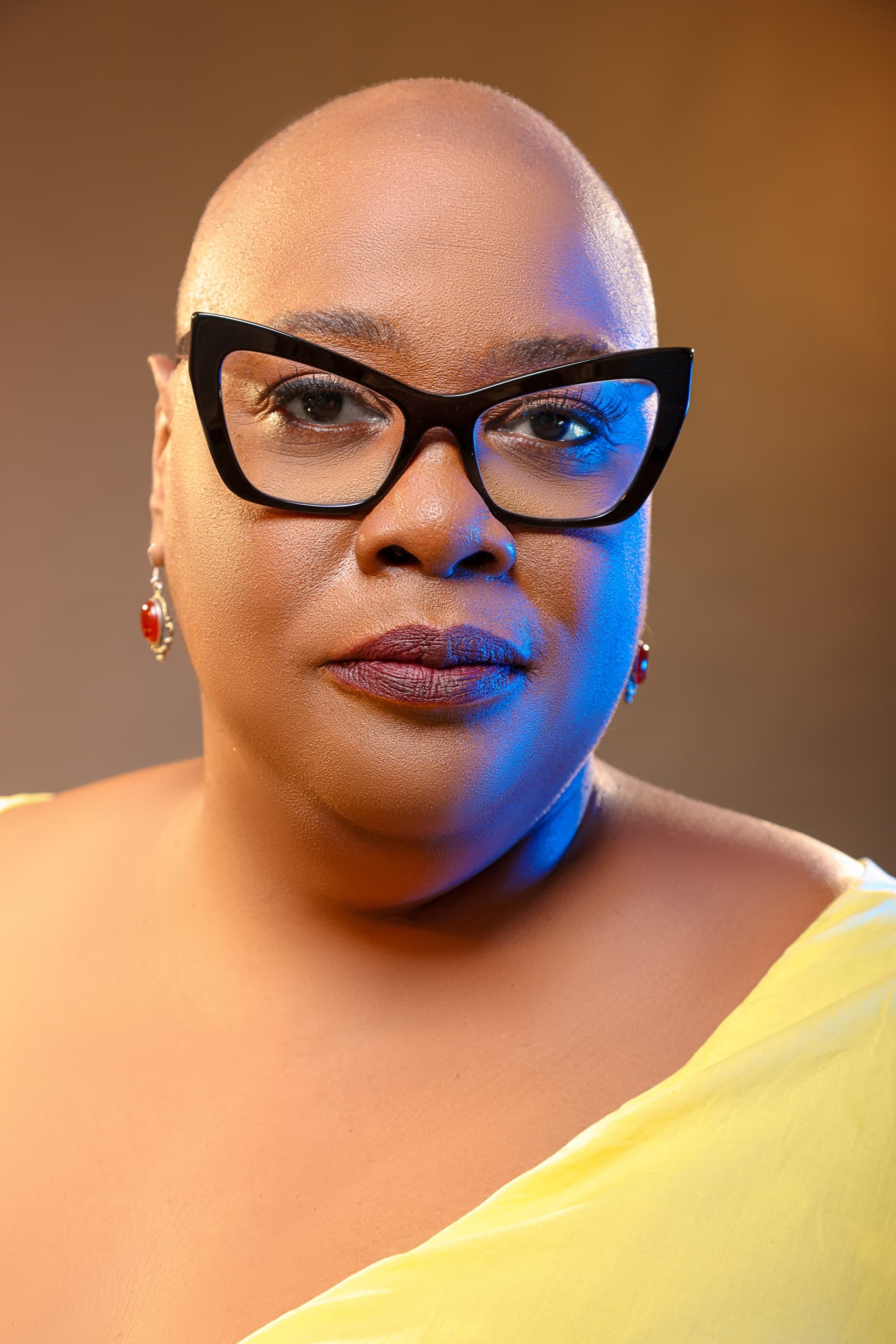 Close-up portrait of Dr. Adriane Johnson-Williams wearing black cat-eye glasses